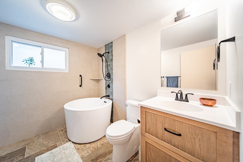 Remodeled bathtub with subway tile surround and modern fixtures